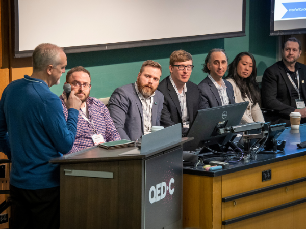 Program leaders from six hub centers sit on a panel